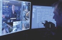 Security guard interacting with robot surveillance feed