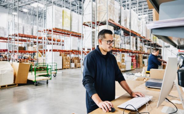 Warehouse worker at computer terminal
