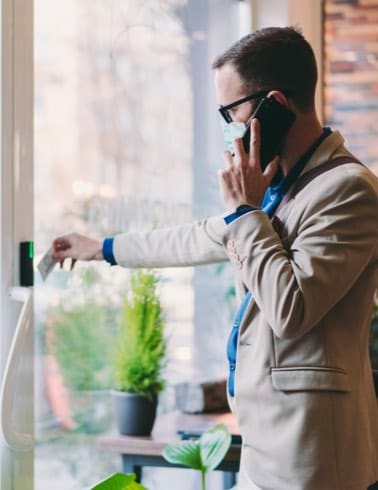 Man on phone waving security key at scanner