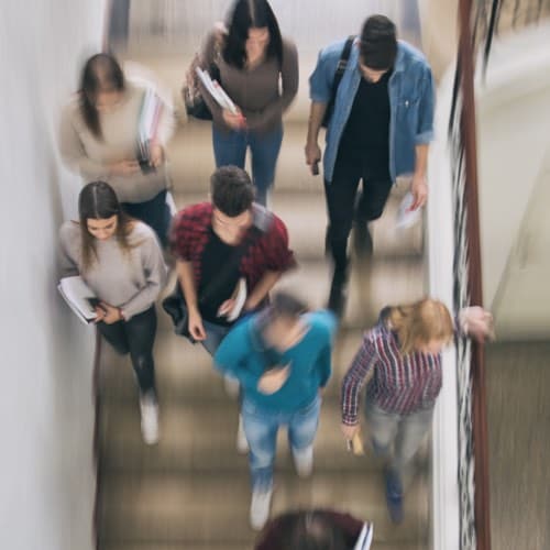 Overhead view of students descending staircase