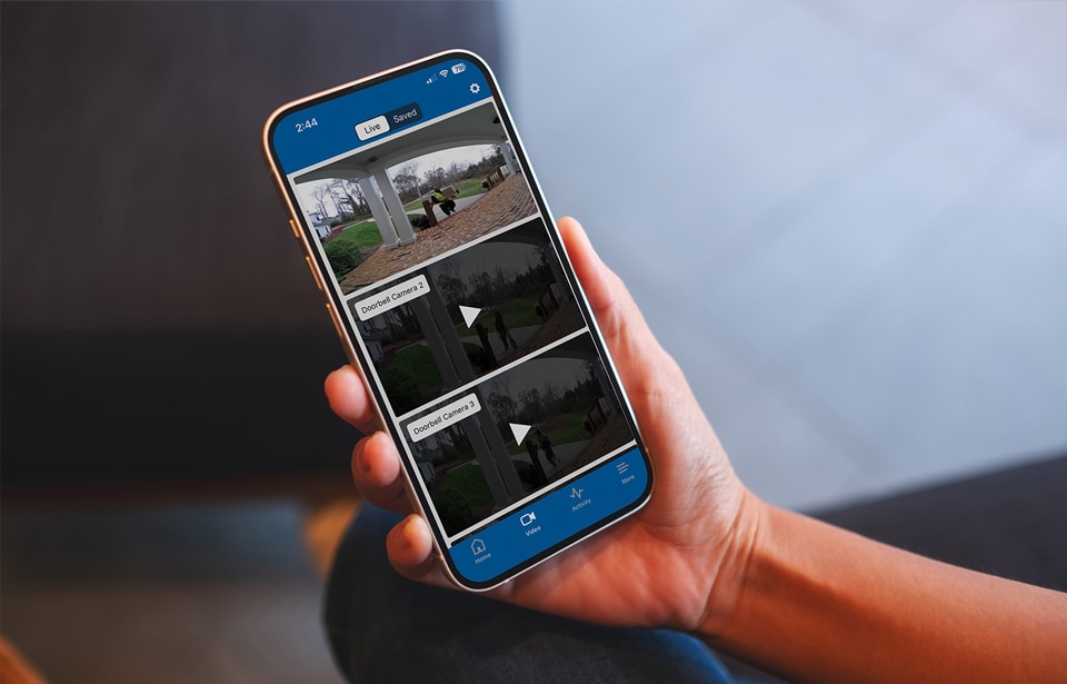 Someone using a cell phone with the ADT Control app