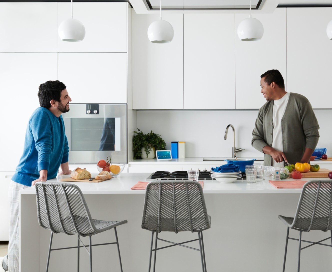 Men in kitchen prepping food with Google Nest Hub (2nd gen) on the counter