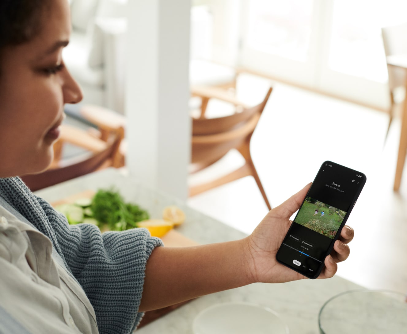 Female viewing event history in Google Home App using Nest Aware subscription Female viewing event history in Google Home App using Nest Aware subscription