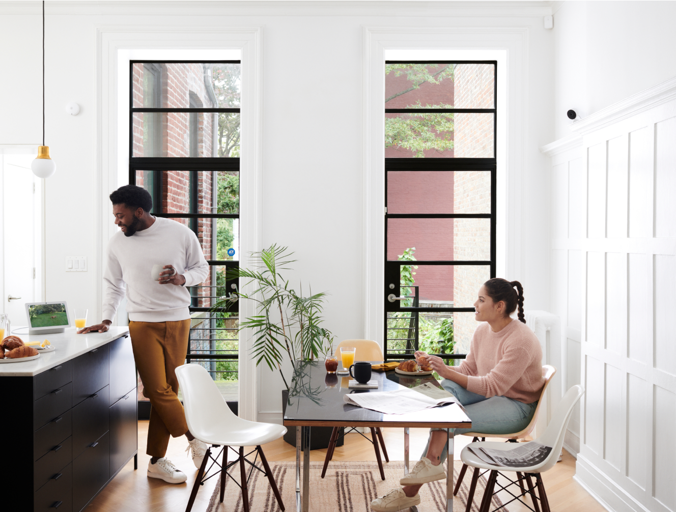 Family in the kitchen with ADT products