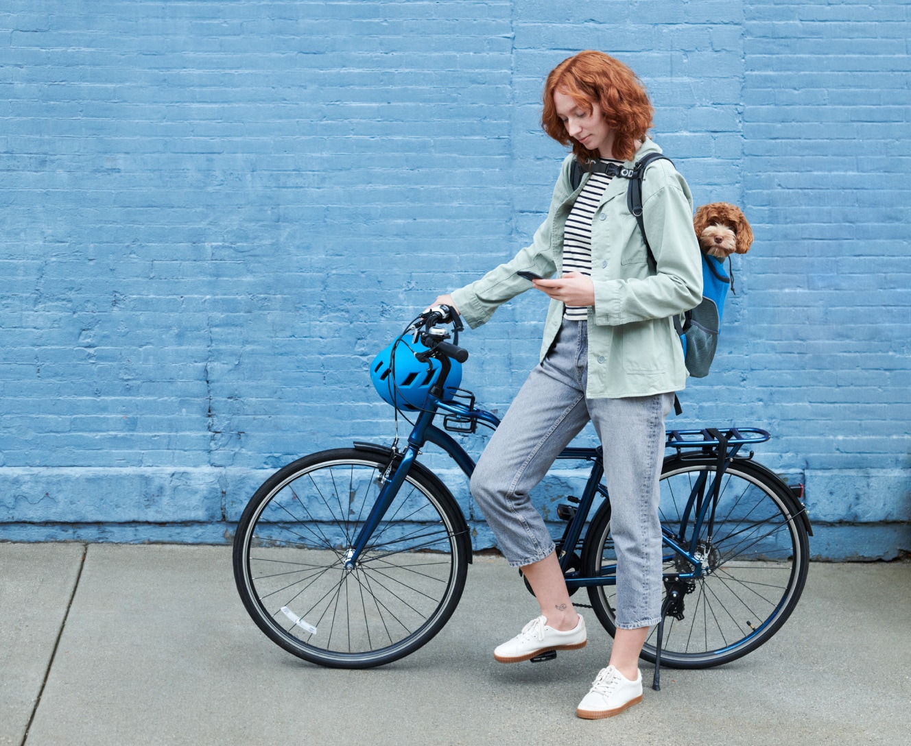 Woman on a bike checking the ADT Plus app on her phone 