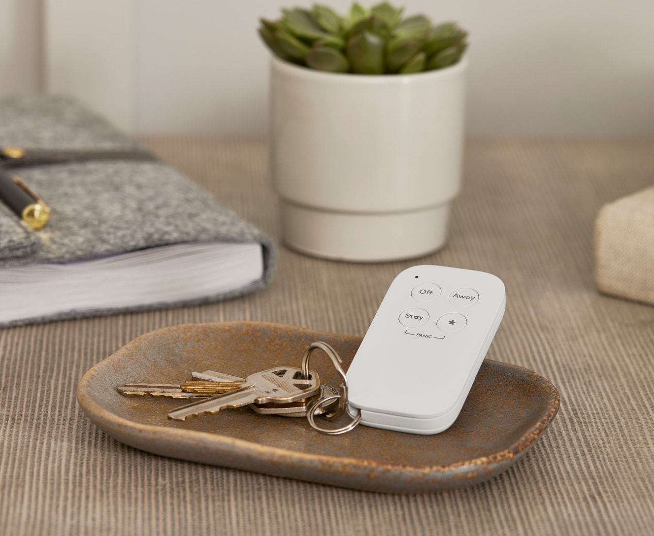 Keychain remote on a table next to keys Keychain remote on a table next to keys