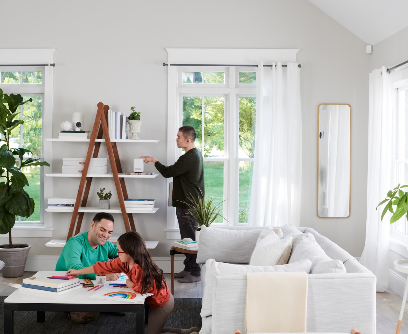 Family in a living room with motion sensor on wall Family in a living room with motion sensor on wall