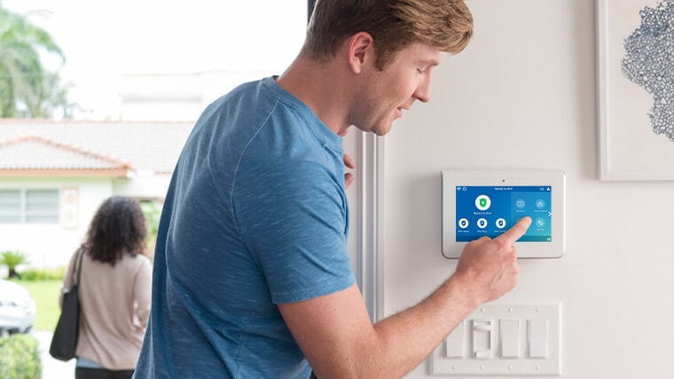 Man pushing a button on a ADT command panel Man pushing a button on a ADT command panel
