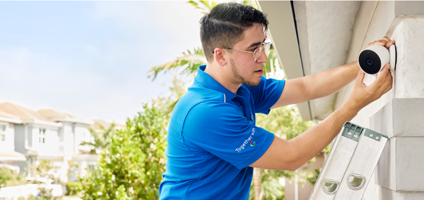 ADT employee installing an outdoor camera