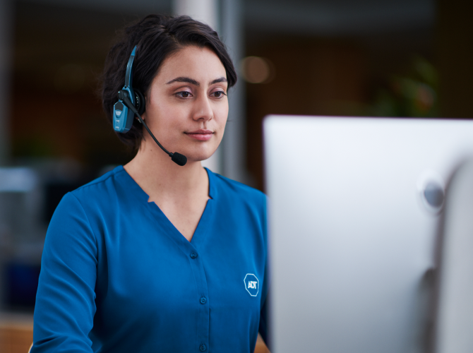 ADT call center employee working and talking into a headset 