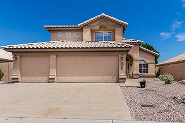 Two story single family house with an ADT sign out front