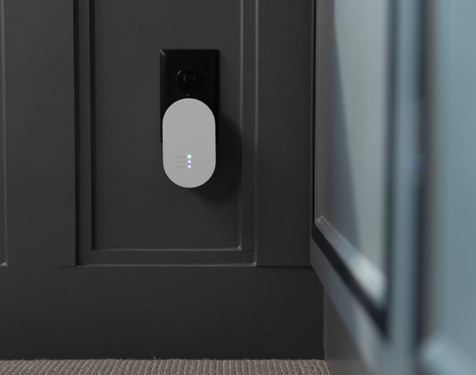 ADT Alarm Range Extender plugged in with LED indicators on