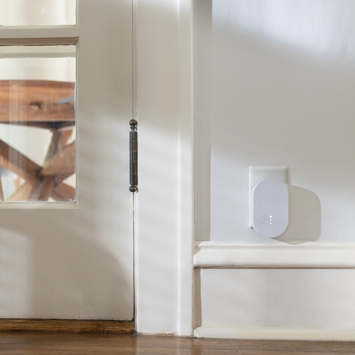 Alarm Range Extender plugged in next to a door