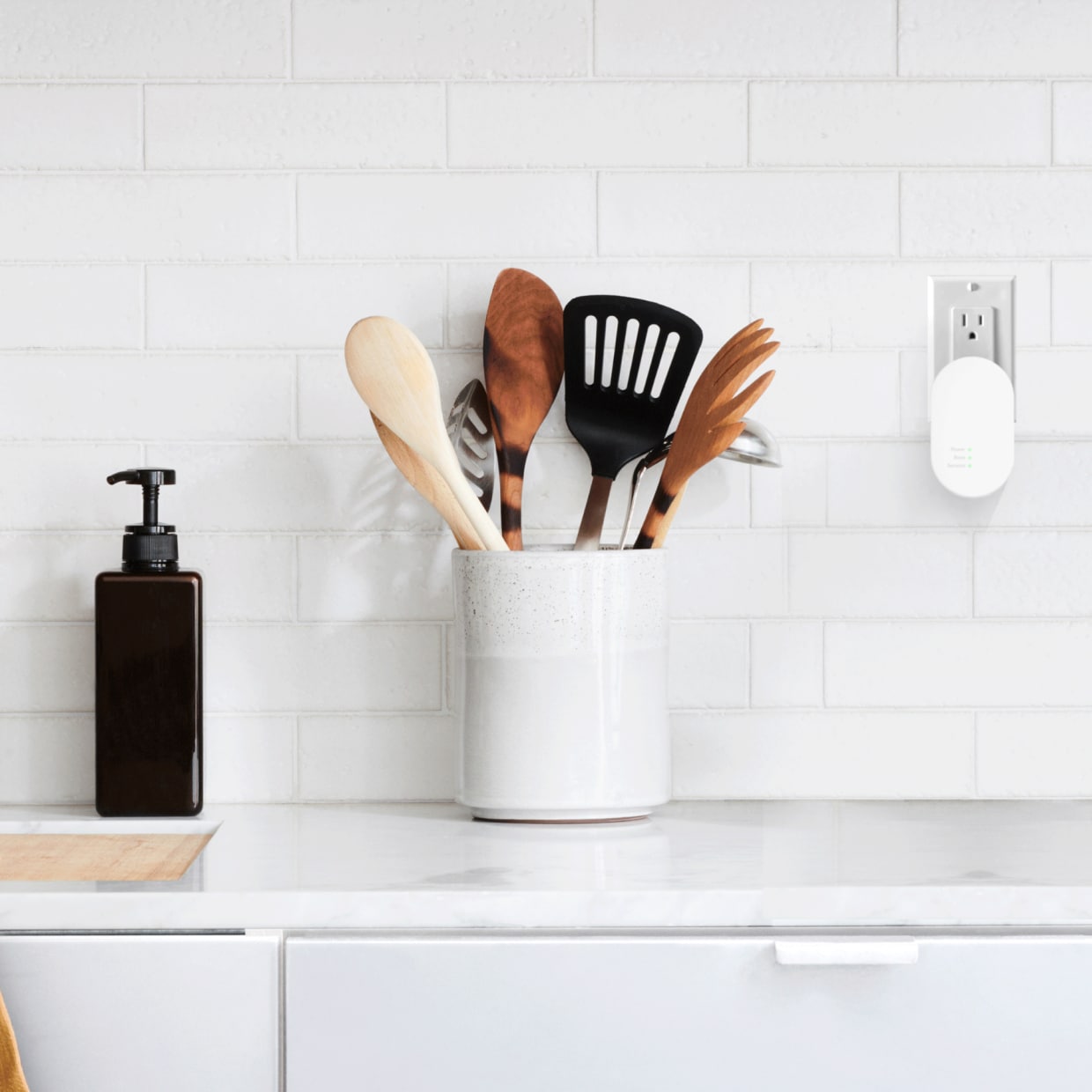 Alarm Range Extender plugged in above a kitchen counter