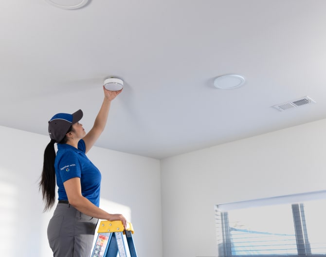 ADT technician installs ADT Smoke and Carbon Monoxide Detector ADT technician installs ADT Smoke and Carbon Monoxide Detector
