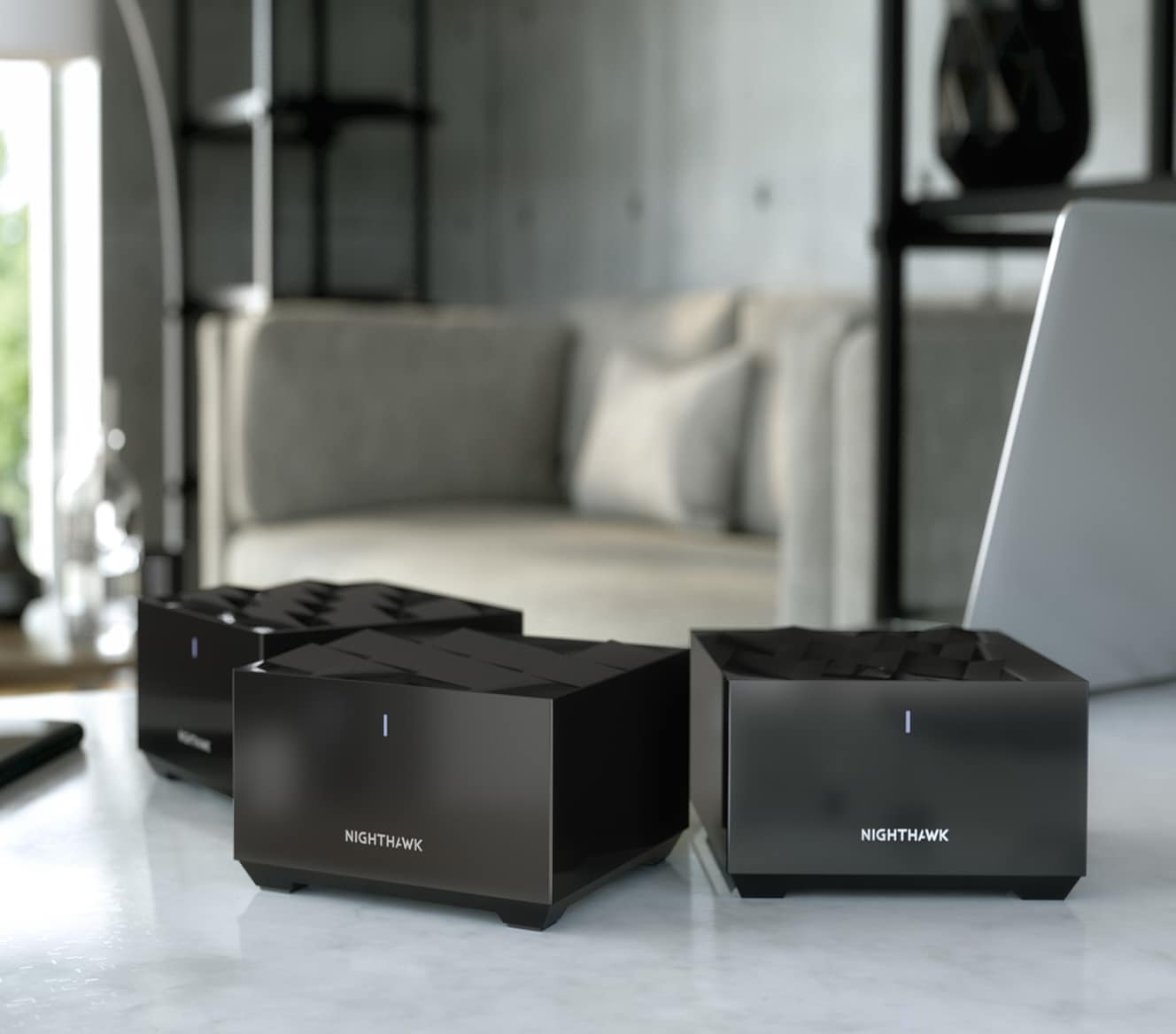 Three Netgear Mesh WiFi devices on a marble countertop Three Netgear Mesh WiFi devices on a marble countertop
