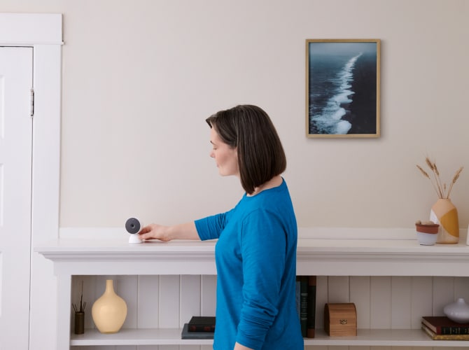 Women adjusting indoor camera in her home