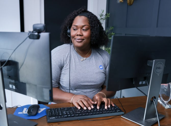 ADT customer service rep typing on her computer and troubleshooting with a customer 