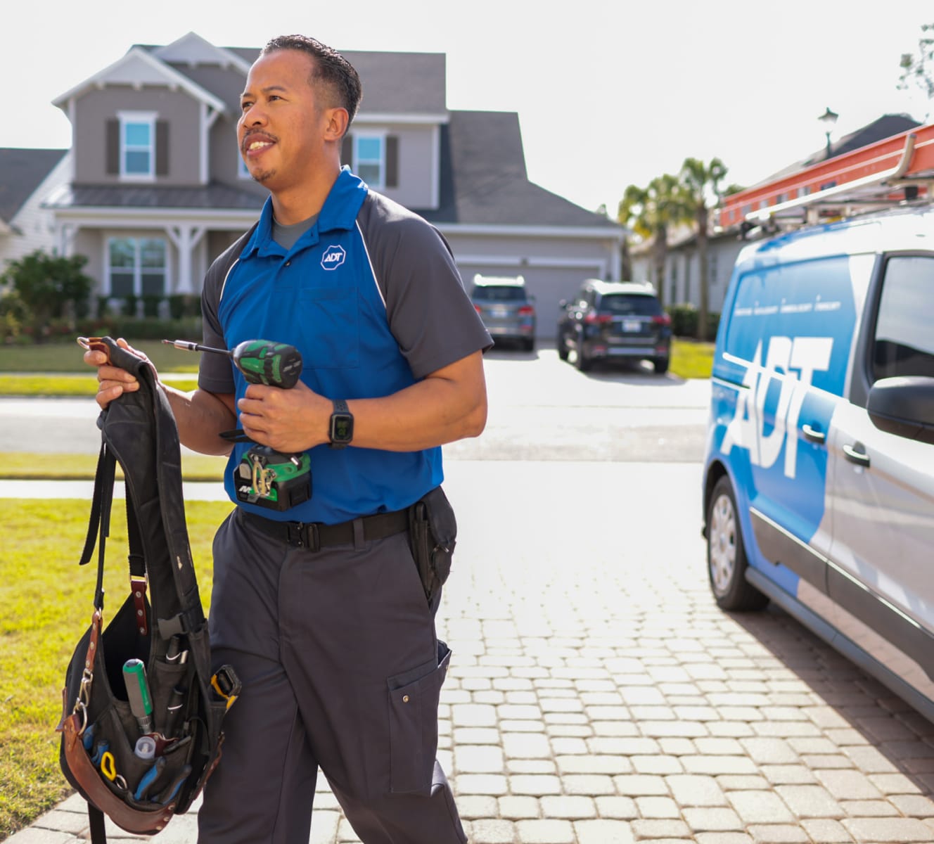 ADT installer walking into a home with his tools