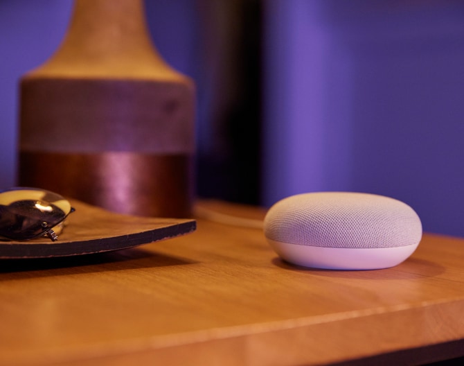 Google Nest Mini 2 Gen on a bedside table Google Nest Mini 2 Gen on a bedside table