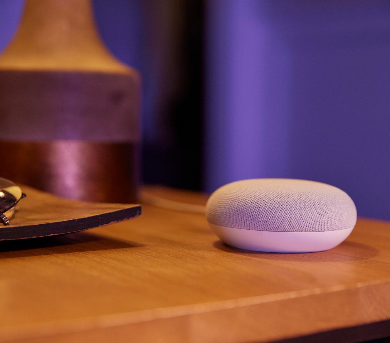 Google Nest Mini 2 Gen on a bedside table Google Nest Mini 2 Gen on a bedside table
