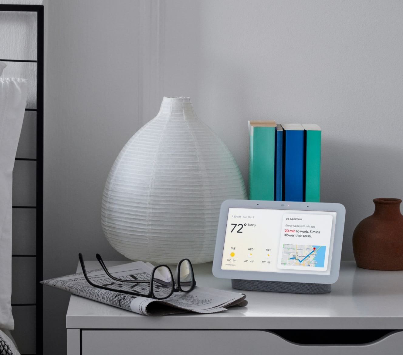 Google Nest Hub 2nd Gen on a bedside table displaying the weather and other stats
