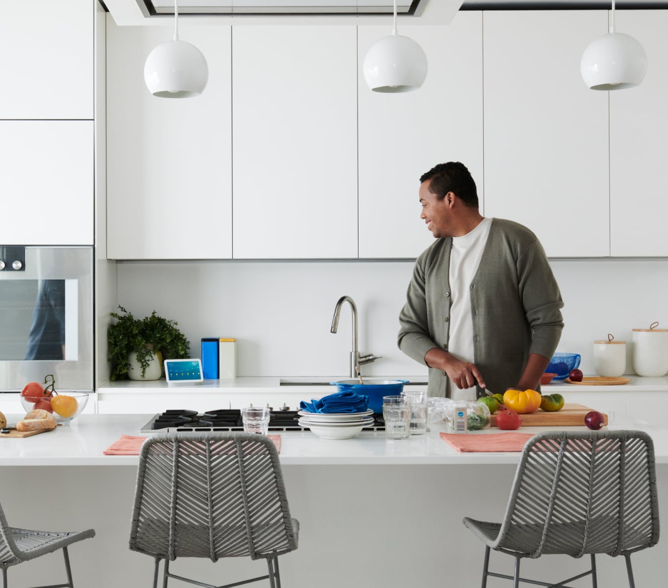 Man using voice control with his Google Nest Hub 2 Gen in the kitchen Man using voice control with his Google Nest Hub 2 Gen in the kitchen