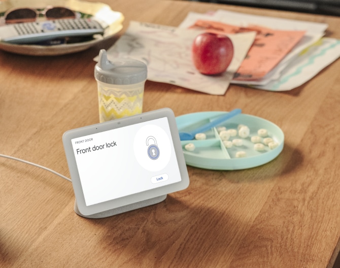 Google Nest Hub 2nd Gen on a kitchen table showing that a home's front door is locked