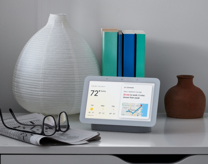 Google Nest Hub 2nd Gen on a bedside table displaying the weather and other stats
