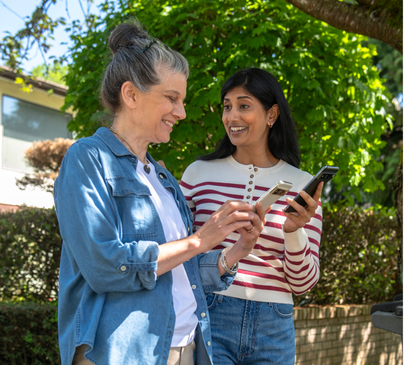 Two women using the Trusted Neighbor on phones Two women using the Trusted Neighbor on phones