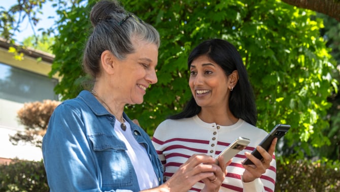 Two women using the Trusted Neighbor on phones Two women using the Trusted Neighbor on phones
